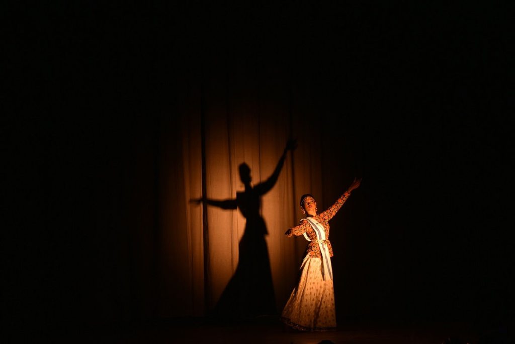 Woman dancing in stage light - a simulation of real life